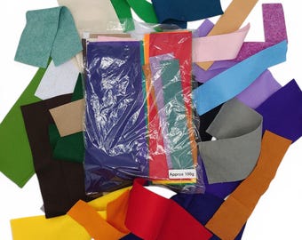 May include: A collection of colorful felt sheets and strips in various shades, including green, blue, red, yellow, and purple. The felt is packaged in a clear plastic bag, with a label that reads "Approx 100g".