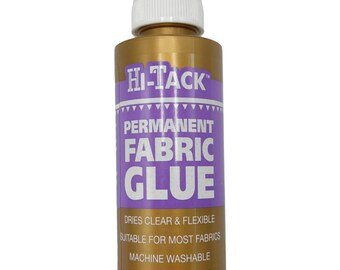 May include: A gold-colored bottle of Hi-Tack Permanent Fabric Glue with a white nozzle. The label features purple and white text, including "Dries Clear & Flexible" and "115ml 4 fl. oz.". Suitable for most fabrics, machine washable, and safe.