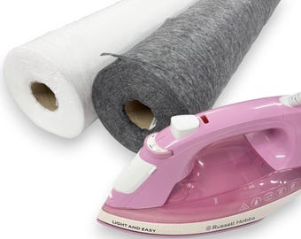 May include: A pink and white iron with the text "LIGHT AND EASY" and "Russell Hobbs" next to two rolls of fabric, one white and one gray.
