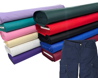 May include: A collection of fabric rolls in various colors, including purple, teal, pink, yellow, white, and red. A pair of navy blue shorts with cargo pockets is also visible.