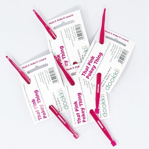 May include: Several pink Pokey Things, a useful tool for threading, turning, pushing, and stuffing. Each tool is packaged with a white card that has the text "That Pink Pokey Thing" and "dookkii".