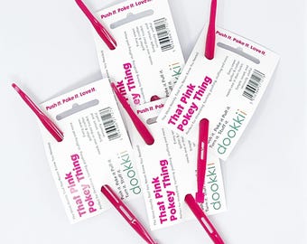 May include: A collection of pink Pokey Things, a handy tool for threading, turning, pushing, and stuffing. Each tool is packaged with a white card that has the text "That Pink Pokey Thing" and "dookkii".