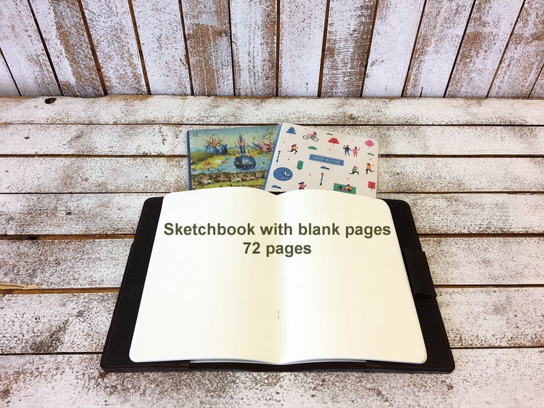 May include: Open sketchbook with a black cover and blank white pages. The text "Sketchbook with blank pages 72 pages" is printed on the front cover.