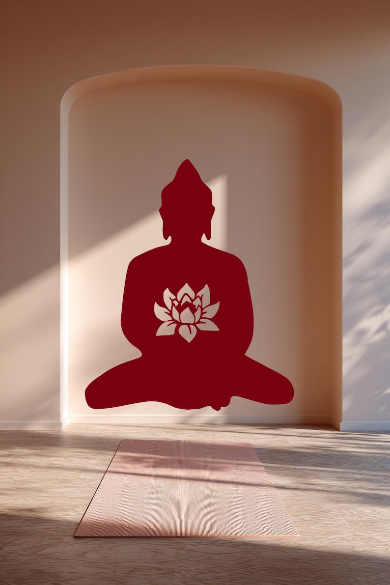 Puede incluir: Silueta roja de un Buda sentado con una flor de loto en el pecho, sobre una pared neutra. Una esterilla de yoga rosa descansa sobre el suelo de madera, creando una est&eacute;tica serena y minimalista.