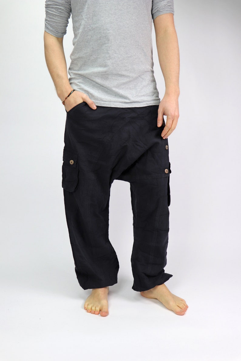 May include: Black cargo pants with a loose, baggy fit. The pants have a drawstring waist and multiple pockets.