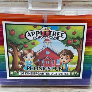 May include: A clear plastic storage case with a white handle, filled with colorful compartments. The case features a label with the text "Appletree Schoolhouse" and "Phonics Fun, 16 Kindergarten Activities", with illustrations of children and a schoolhouse.