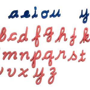 May include: A set of wooden alphabet letters in cursive script. The vowels a, e, i, o, and u are blue, while the remaining letters are red.