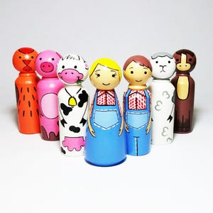 May include: Set of seven hand-painted wooden peg dolls. The dolls are painted to resemble farm animals and people. The set includes a rooster, pig, cow, farmer, farmer, sheep, and a horse.