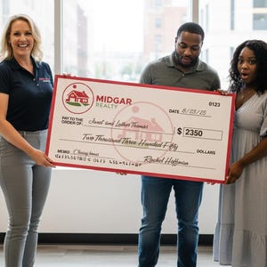 May include: A large check from Midgar Realty is held by three people. The check is made out to Janet and Luther Thomas for $2350, dated 8/23/25. The check has a red border and the Midgar Realty logo.