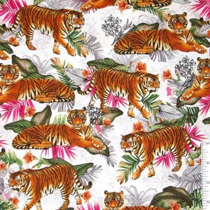 May include: A white fabric featuring a repeating pattern of orange and black tigers in various poses, interspersed with green tropical leaves, pink palm fronds, and orange flowers. A ruler showing 6 inches is visible along the bottom edge.