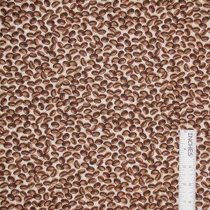 May include: A fabric featuring a repeating pattern of brown coffee beans on a light cream background. An L-shaped ruler is positioned in the lower right corner, showing measurements in inches with the text Steel City Stitches printed on it.
