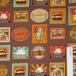 May include: A brown fabric featuring a repeating pattern of coffee-themed labels, including text like Cafe de Kenya and Kanto Coffee, alongside a white L-shaped ruler showing measurements in inches to indicate the scale of the printed designs.