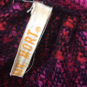 May include: A close-up of a white fabric label with the text "MR. MORT&reg;" printed in orange.