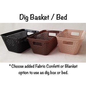 May include: Three plastic storage baskets in black, brown, and beige. The baskets have a woven pattern and are labelled "Dig Basket / Bed". The text below the baskets reads "Choose added Fabric Confetti or Blanket option to use as dig box or bed."