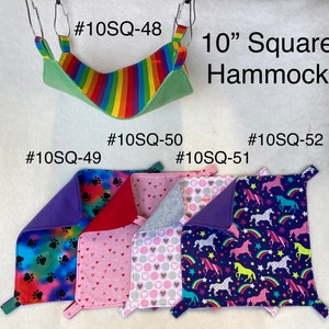 May include: A set of 10-inch square pet hammocks in various colors and patterns. The hammocks are made of soft fabric and have a hanging loop at each corner. The patterns include paw prints, hearts, polka dots, and unicorns. The hammocks are labeled with product numbers #10SQ-48, #10SQ-49, #10SQ-50, #10SQ-51, and #10SQ-52.