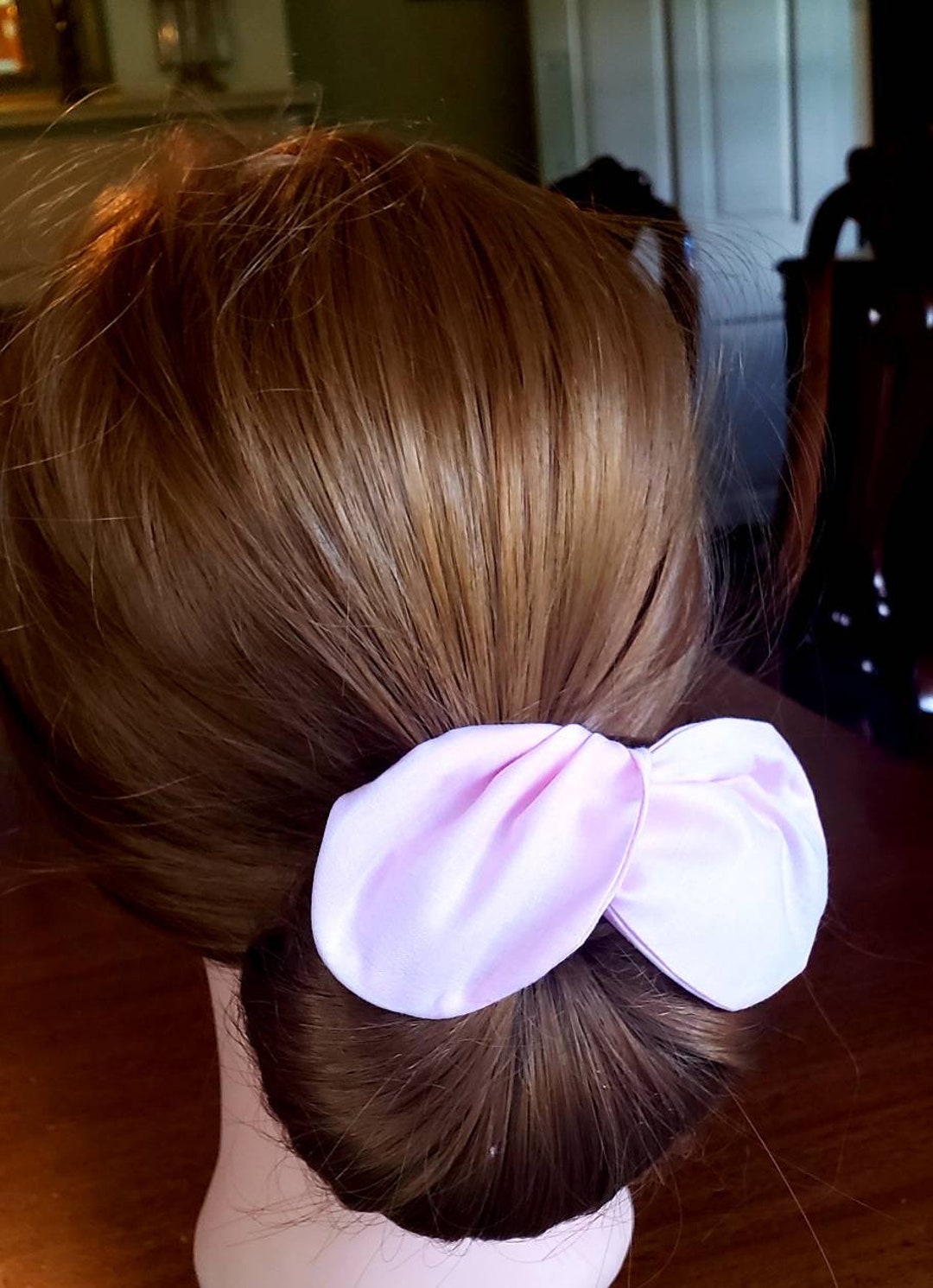 Image of Twisted ballerina bun preppy hairstyle