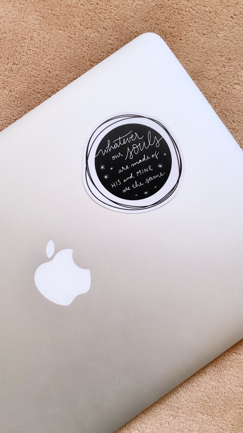 May include: A black and white sticker with the text "Whatever our Souls are made of HIS and MINE are the same" on a silver laptop.