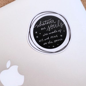 May include: A black and white round sticker with the text "Whatever our souls are made of HIS and MINE are the same" with stars around the text.