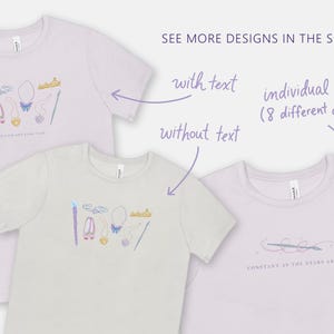 May include: Three t-shirts with different designs. The first t-shirt is lavender and features a crown, wand, shoes, and other fairy tale-themed icons. The second t-shirt is white and features the same icons as the first t-shirt. The third t-shirt is lavender and features a simple design of a brush with a star and the text "CONSTANT AS THE STARS ABOVE".