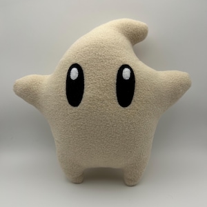 May include: A set of three ceramic mugs with a speckled, matte finish in cream, light grey, and dark grey. Each mug has a simple, minimalist design, suitable for coffee or tea.