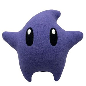 May include: A star-shaped plush pillow in a deep purple colour. It has two large, oval black eyes with white highlights. The design includes four points and a small, rounded bottom, resembling a cartoon character.