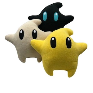 May include: A set of three ceramic mugs with a speckled, matte finish in cream, light grey, and dark grey. Each mug has a simple, minimalist design, suitable for coffee or tea.