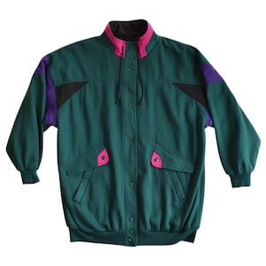 May include: A teal jacket with a black collar and accents of purple and pink. The jacket has a button-up front, two front pockets with pink accents, and a drawstring hood. The sleeves are long and the jacket has a relaxed fit.