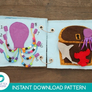 May include: A felt book with a purple octopus on the left page and a brown treasure chest with a shark and lobster on the right page. The octopus has eight tentacles with colorful beads on each one. The numbers 1 through 8 are written on the page next to each tentacle. The treasure chest has a keyhole and a purple octopus with pink tentacles coming out of the top.