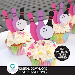 May include: A set of three cupcake toppers featuring pink, purple, and black bowling pins with a white bowling ball. The toppers are on top of cupcakes with white frosting and colorful sprinkles.