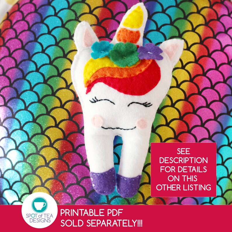 May include: A white felt tooth with a rainbow unicorn face, purple shoes, and a rainbow mane with flowers. The tooth is on a rainbow background with a text overlay that says "PRINTABLE PDF SOLD SEPARATELY!!!" and "SEE DESCRIPTION FOR DETAILS ON THIS OTHER LISTING".