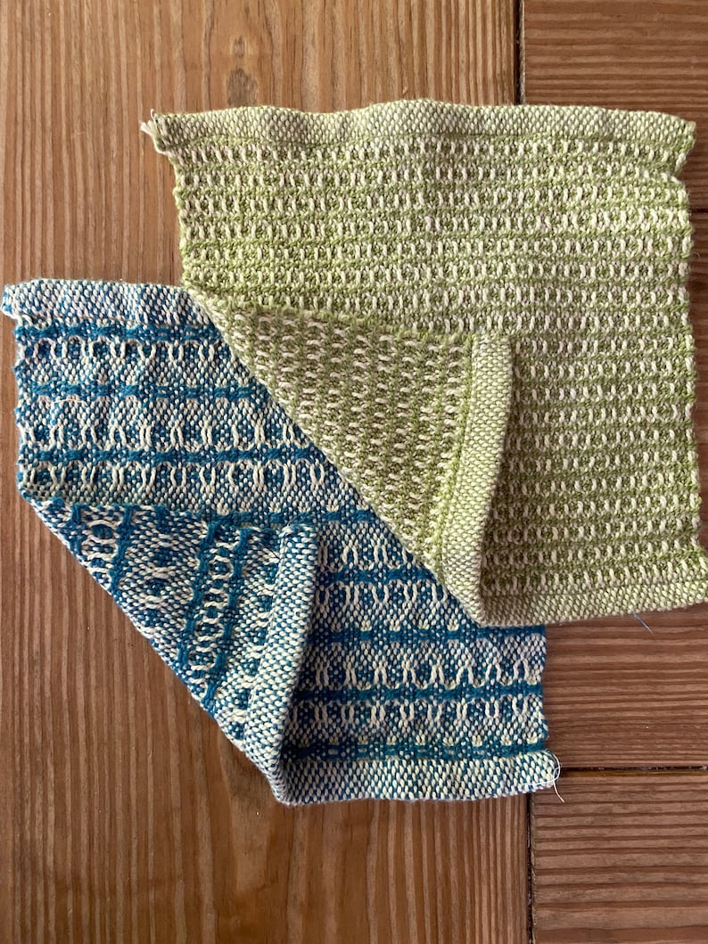May include: Two woven fabric squares, one in a light green and white pattern and the other in a blue and white pattern.