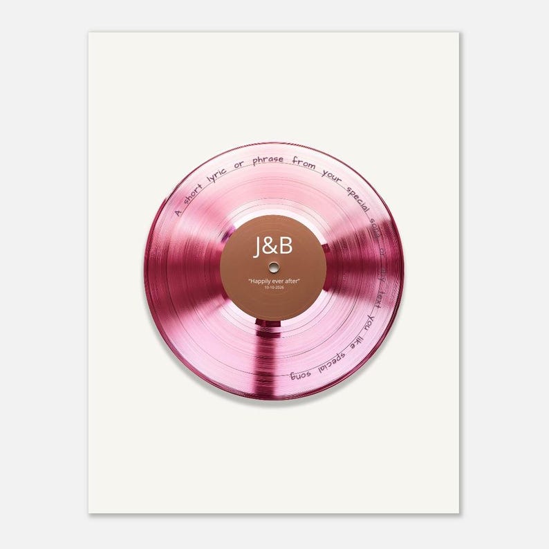 May include: A circular pink vinyl record featuring a brown center label with the white text J&B and Happily ever after 10-10-2024. The record surface includes the black handwritten text A short lyric or phrase from your special song or any text you like special song.