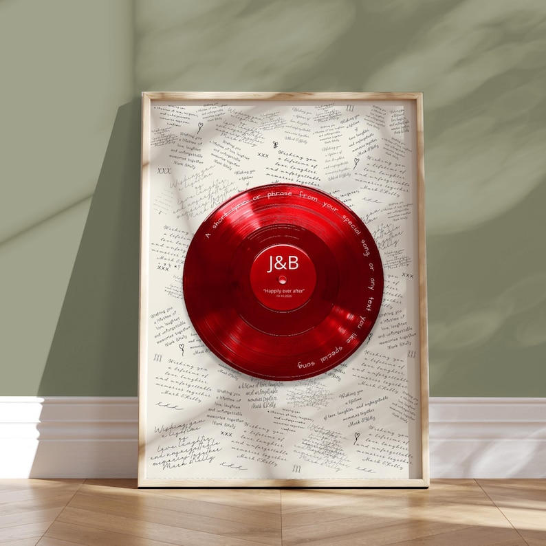 May include: A framed wall art piece featuring a glossy red vinyl record centered on a white background covered in repeated handwritten text. The record label displays the letters J&B in white, with text around the rim reading A short lyrics or phrase from your special song or any text you like special song.