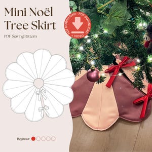May include: A Mini Noël Tree Skirt PDF sewing pattern featuring a scalloped edge design. The physical skirt is made of alternating dusty rose and light pink fabric panels, accented with two bright red ribbon bows at the centre opening.