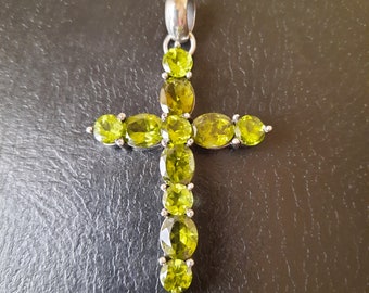 Handmade silver and faceted peridot cross