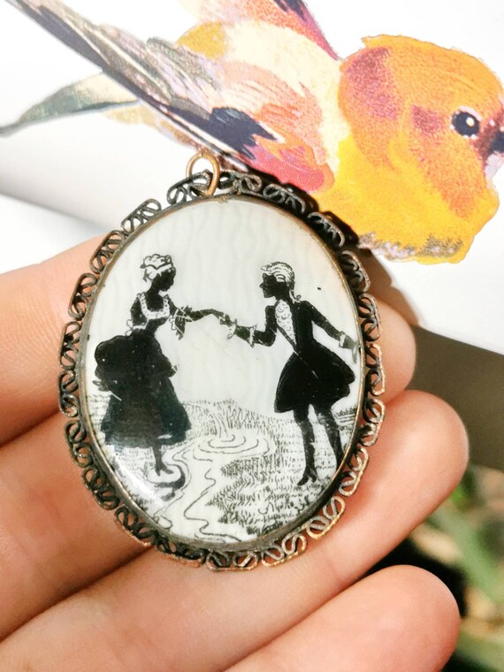 Art Deco Porcelain Locket Pendant Scissors Cut Mot