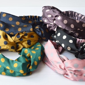 May include: Six knotted headbands in a variety of colours and polka dot patterns. The headbands are made from a soft, stretchy fabric and are ideal for adding a touch of style to any outfit.