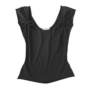 May include: Black sleeveless top with a scoop neck and tie details at the shoulders.