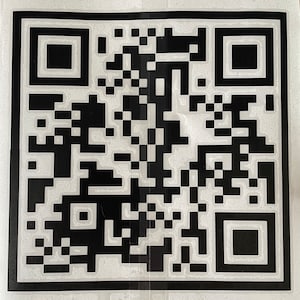 May include: A handmade, wooden serving tray with a natural finish. The tray features a rectangular shape with rounded corners and raised edges. It is designed with two integrated handles for easy carrying. The wood grain is visible throughout the tray.