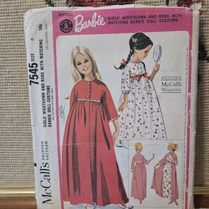 May include: Vintage McCall's sewing pattern for a Barbie doll nightgown and robe set. The pattern features illustrations of the nightgown and robe, along with a matching doll costume. The pattern is size 6 and includes the Barbie logo.