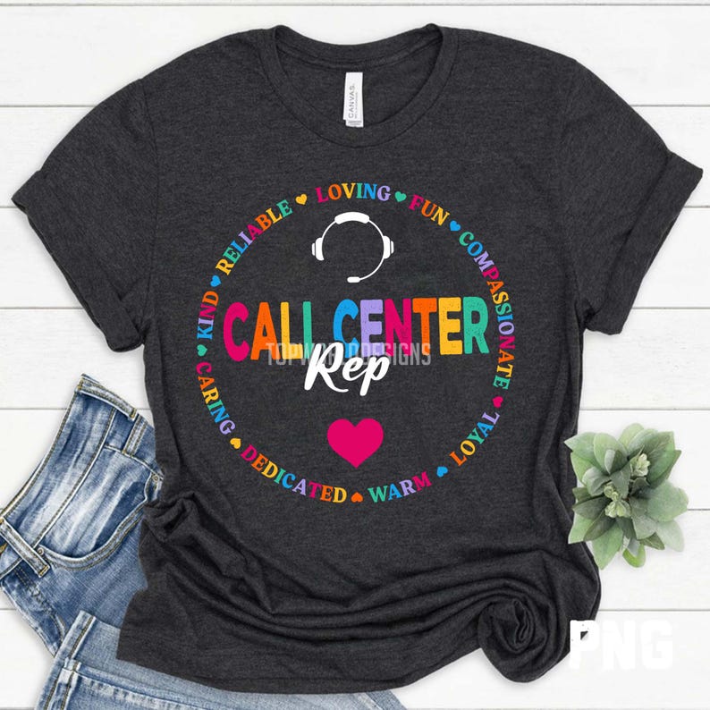 May include: A dark grey t-shirt with a vibrant graphic. The design includes the text "CALL CENTER Rep" in a circular pattern, surrounded by words such as "reliable" and "loving". A pink heart and headset are also featured.
