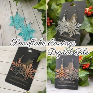 May include: Four pairs of snowflake earrings, each pair featuring a different color gradient. The earrings are displayed on black card stock with the text "HANDCRAFTED BY JENNIFER LYNN" and "WIREDBYJENNIFERLYNN.ETSY.COM".