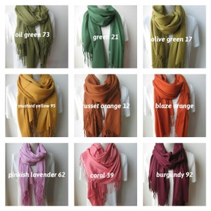 May include: Nine different colors of scarves with fringe. The colors are oil green, green, olive green, mustard yellow, russet orange, blaze orange, pinkish lavender, coral, and burgundy.