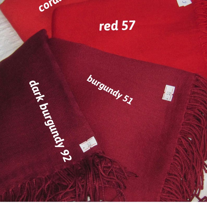May include: Three fabric swatches in different shades of red. The top swatch is a bright red labeled "red 57". The middle swatch is a darker red labeled "burgundy 51". The bottom swatch is a deep burgundy labeled "dark burgundy 92".