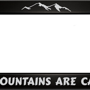 May include: Black license plate frame with a white mountain range design and the text "THE MOUNTAINS ARE CALLING" in white.