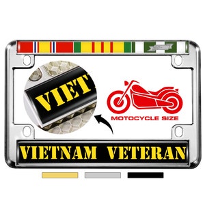 May include: A chrome motorcycle license plate frame with a black and yellow "VIETNAM VETERAN" inscription. The frame features a red motorcycle silhouette and a multi-colored ribbon with the text "60-75" on it.