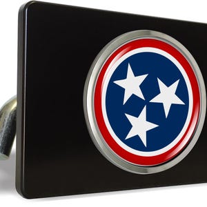 May include: Black hitch cover with a chrome ring around a blue circle with three white stars and a red and white border. The circle has a glossy finish.