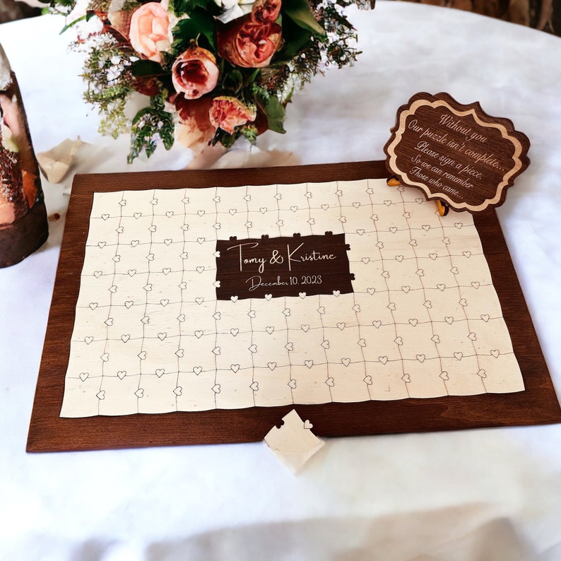 A photo of a personalized wooden wedding guest book puzzle
Custom wooden wedding guest book with customizable names and date. Features Walnut wood-colored frame ( Rectangle) and middle ( Rectangle ) section. Puzzle pieces designed with natural color.