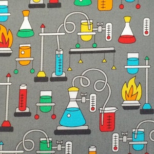 May include: A gray fabric with a repeating pattern of colorful science lab equipment, including beakers, flasks, test tubes, and Bunsen burners.
