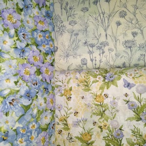 May include: Three fabric swatches with floral patterns. The first swatch features a blue and purple floral pattern. The second swatch features a light green background with a blue floral pattern. The third swatch features a yellow background with a green floral pattern and bees.